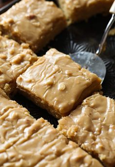 peanut butter fudge brownies on a black plate with a spoon in the middle