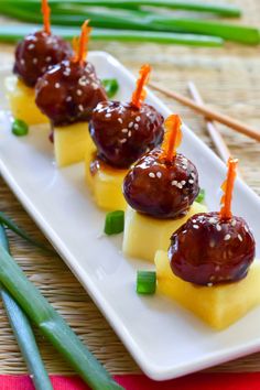 small appetizers are arranged on a plate with chopsticks