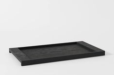 an empty black tray on a white background