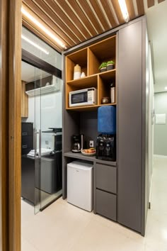 a kitchen area with a microwave, dishwasher and cabinets