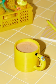 a yellow coffee mug sitting on top of a counter