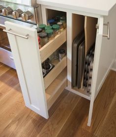 an open cabinet in the middle of a kitchen