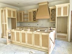 an unfinished kitchen with wooden cabinets and drawers