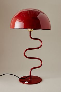 a red table lamp on a white background