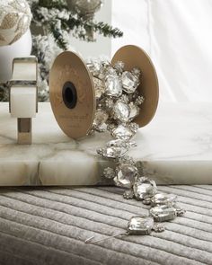 a close up of an object on a table near a christmas tree and other decorations