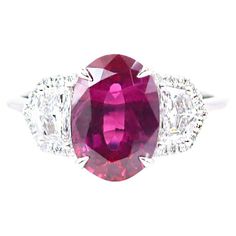 an oval cut ruby and diamond ring