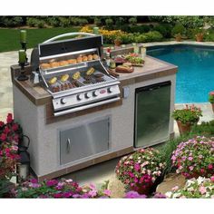 an outdoor bbq grill next to a pool with flowers and potted plants around it