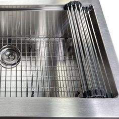 a stainless steel kitchen sink with grids on the bottom