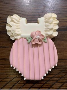 a cake shaped like a baby's diaper with ruffles and flowers