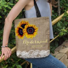 a woman carrying a bag with sunflowers on it