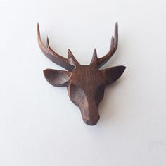 a wooden deer head mounted on the wall