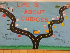 a bulletin board that says life is about choices with a road going through the center