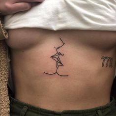 a woman's stomach with a small tattoo on her side, and the word i love