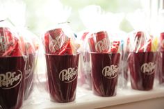 plastic cups are lined up on the window sill to be filled with candy canes