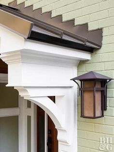 an outside view of a house with a white door and brown trim on the side