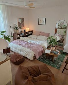 a bedroom with a bed, couch and mirror in it's centerpieces