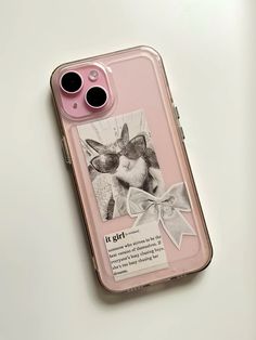 a pink phone case with an image of a dog and bow on the back, sitting on a white surface