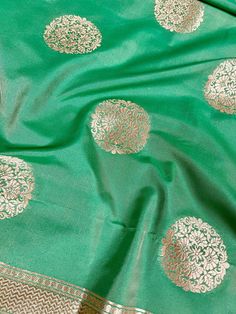 Beautiful Green Color Handmade Dupatta with Chakra design and floral design on the borders. Super Light weight and very easy to carry. Can be worn with a Suit or lehenga easily. Item: DupattaBase color : Light Green Color Zari Work : Gold Fabric : Premium quality Banarasi Soft Silk (Non-Pure)Work : Zari Weaved with tasselsLength of the dupatta : 92 inches Width of the dupatta : 37 inches Store Policies - No return or exchange will be accepted for color variations. - No return or exchange will be Men's Ethnic Wear, Bandhani Saree, Kantha Stitch, Buy Lights, Gold Fabric, Cotton Silk, Cotton Linen, Light Green, Party Wear