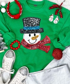 Introducing our "Faux Sequin Snowman Graphic Shirt" – a whimsical and festive addition to your winter wardrobe. This shirt features a charming snowman graphic adorned with faux sequins, providing a sparkling appearance without the actual texture of real sequins.
Available in short sleeves, long sleeves, or as a cozy sweatshirt, our "Faux Sequin Snowman Graphic Shirt" offers versatility for various occasions and weather. The graphic sequins are a graphic representation, ensuring a smooth an Christmas Sequin Top For Festive Occasions, Winter Glitter Long Sleeve Tops, Glitter Long Sleeve Winter Tops, Glitter Long Sleeve Tops For Winter, Long Sleeve Glitter Top For Winter, Long Sleeve Glitter Tops For Winter, Sequin Top For Christmas Holiday, Winter Crew Neck Top With Glitter Print, Winter Glitter Print Crew Neck Top