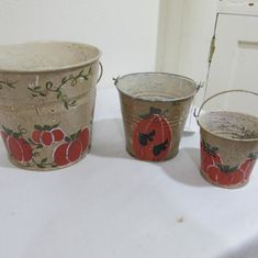 three buckets sitting on top of a white table