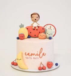 a cake decorated with figurines sitting on top of it