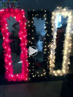 two large mirrors decorated with lights and garlands, one in red and the other in black