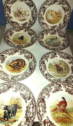 six plates with animals painted on them