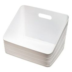 a stack of white square plates on a white background with a plastic handle for each plate