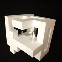 a paper model of a house with two people in it