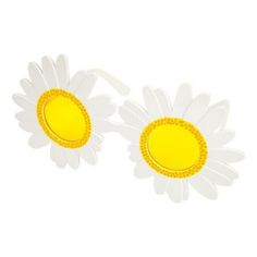 two white and yellow flower shaped brooches sitting next to each other on a white surface