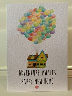 there is a card with a house and balloons in the shape of a house on it