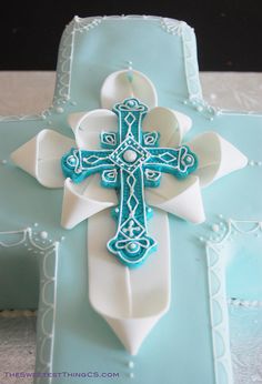 a blue and white cake with a cross on it