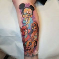 a person with a mickey mouse tattoo on their leg