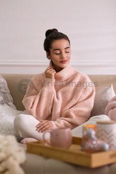 a woman sitting on a couch with her eyes closed