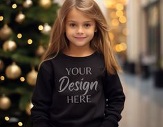 Enhance your apparel designs and showcase them in a professional and realistic manner with our mockups. Whether you're a designer, entrepreneur, or simply looking to visualize your creative ideas, our mockups are the perfect tool to bring your designs to life. This mockup features a black Gildan 18000B youth crewneck sweatshirt. You will receive 1 high-resolution image, ensuring every detail of your design is beautifully displayed. Please note that this is a digital product, and no physical item Black Christmas Sweatshirt For Streetwear, Black Custom Print Top For Winter, Black Custom Print Tops For Winter, Winter Black Top With Custom Print, Black Sweatshirt Winter Gift, Custom Print Black Winter Sweatshirt, Black Custom Print Sweatshirt For Winter, Black Crew Neck Sweatshirt For Gift, Winter Black Sweatshirt With Custom Print