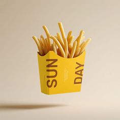 a yellow box filled with french fries on top of a table