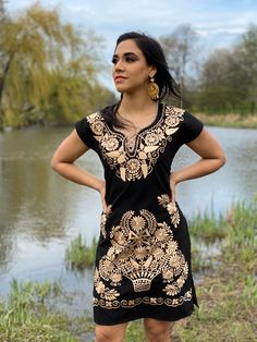 This Beautiful Mexican Gold Floral Dress is the perfect dress for a fun night out or a special event. It's made out of cotton and is full of gold embroidered details. This dress has ties on the back for an adjustable fit. The earrings you can buy too and you can find here https://www.etsy.com/es/listing/637147293/filigrana-redonda-filigrana-clasica?ref=shop_home_active_1&pro=1&frs=1 Mexican Fancy Dress, Mexican Traditional Dress, Mexican Bridesmaid Dresses, Gold Floral Dress, Gold Embroidered Dress, Mexican Stuff, Vestido Charro, Traditional Mexican Dress, Mexican Embroidered Dress