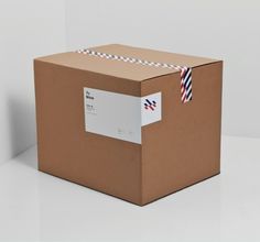 a brown box with a red, white and blue striped ribbon on it's side