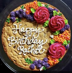 a birthday cake decorated with flowers and the words happy birthday rachel