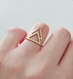 14K 9K Double Triangle ring, Geometric Statement ring, Gold Thumb ring, Modern Solid Gold Ring, Geometric Boho Jewelry, FREE EXPRESS SHIPPING Modern double triangle ring made in 14K or 9K solid gold. Stack it with other rings or wear separately! Perfect thumb ring for trendy looks! ------------------------------------------------- R I N G S P E C S Band width: 1.4mm Triangle dimensions: 14.5mmx17mm Polished/Shiny finish If you would like hammered or matte finish please leave us a note during che Modern Brass Stackable Rings For Gift, Modern Brass Stackable Rings As Gift, Adjustable Geometric Rings As Gift, Adjustable Geometric Rings For Gifts, Unique Geometric Rings For Gifts, Minimalist Geometric Rings For Gifts, Gold Thumb Ring, Gold Thumb Rings, Ring Geometric