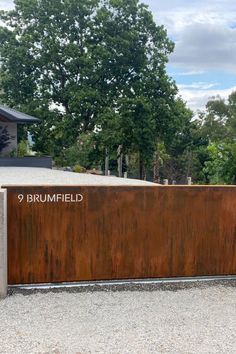 the entrance to brumfield cemetery with a wooden fence and trees in the background