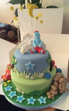 a birthday cake decorated with animals and stars