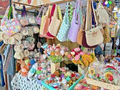 many handbags and purses are on display at the market