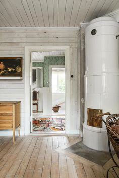 a room with white walls and wood floors