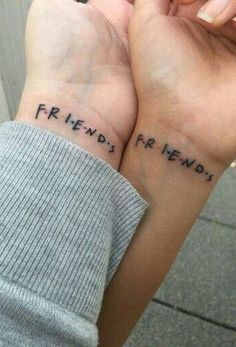 two people holding hands with the words friends forever written on them