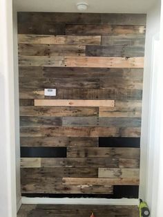 a bathroom with wood planks on the wall