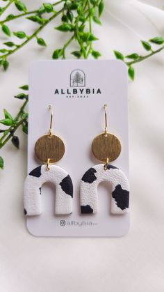 the black and white cow print earrings are on display