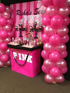 a pink party with balloons and decorations