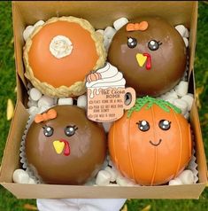 a box filled with chocolate covered donuts and pumpkins