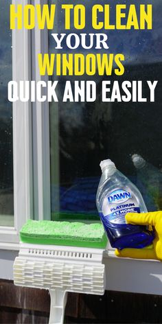 a window cleaner is cleaning the outside of a house with a green sponge on it